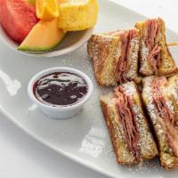 Monte Cristo · Grilled ham and Swiss cheese sandwiched between two extra thick slices of French toast.   Se...