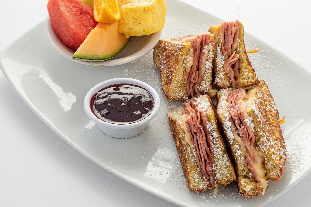 Monte Cristo · Grilled ham and Swiss cheese sandwiched between two extra thick slices of French toast.   Served with a side of raspberry sauce.