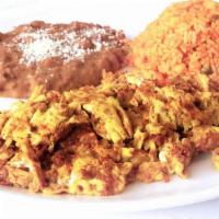 Huevos Con Chorizo · Two eggs scrambled with spicy chorizo.