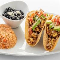 Baja Breakfast Tacos · Two corn tortillas filled with scrambled eggs and spicy chorizo.  Topped with avocado, salsa...