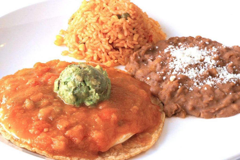 Huevos Rancheros · A grilled corn tortilla topped with two over medium eggs and homemade ranchero sauce.