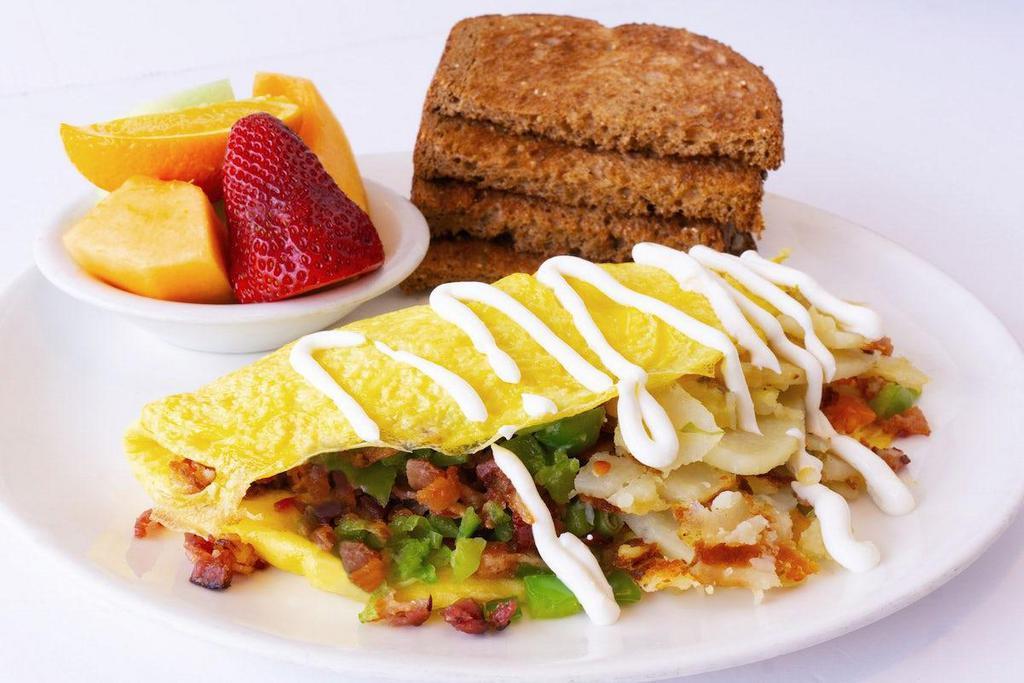 The Rancher Omelet · Bacon, homefries, green bell pepper, tomato, green onion.  topped with sour cream.