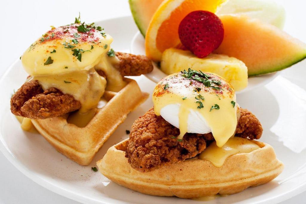 Chicken & Waffle Benedict · Two Belgian waffle quarters topped with crispy chicken tenders, poached eggs and holandaise sauce.