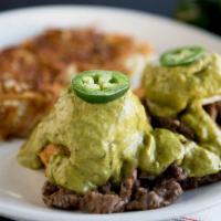Border Benedict · Poached eggs, seasoned carne asada and sweet corn cakes topped with our homemade poblano sau...