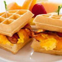 Waffle Sandwich · A Belgian waffle sandwich filled with scrambled eggs , cheddar cheese and applewood bacon.
