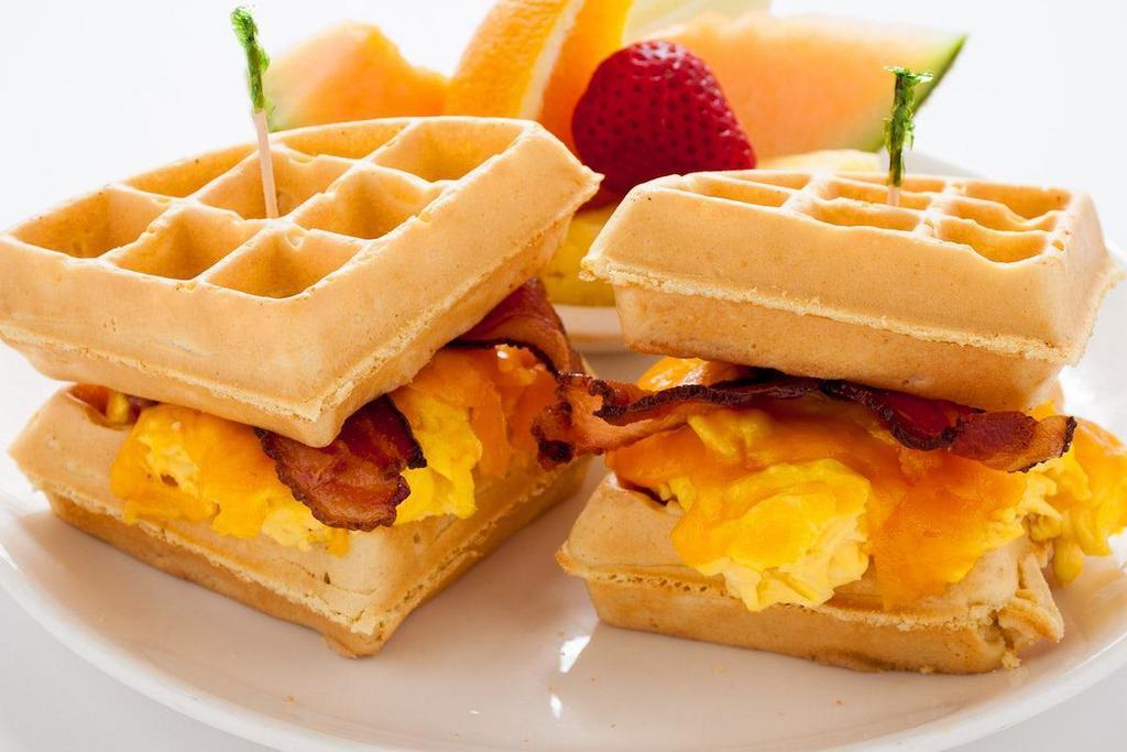 Waffle Sandwich · A Belgian waffle sandwich filled with scrambled eggs , cheddar cheese and applewood bacon.