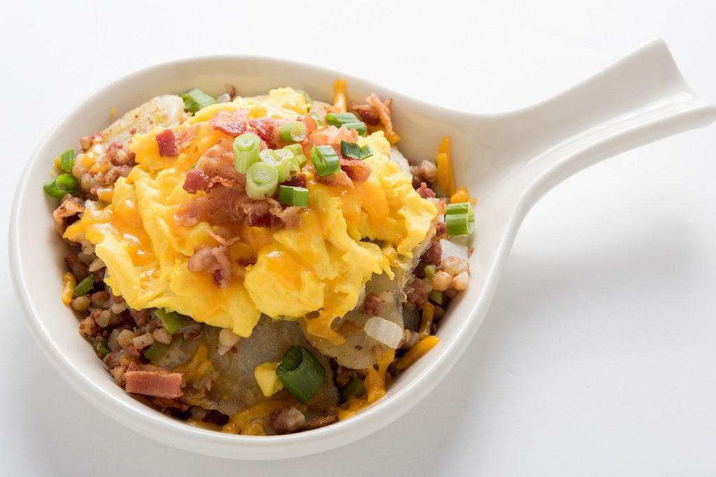 Hash Skillet · Homefried potatoes sauteed with corned beef hash, onions and bell peppers.  Topped with scrambled eggs, cheddar cheese, chopped bacon and green onion.