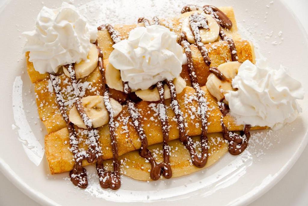 Nutella Crepes · Three homemade crepes filled with Nutella and your choice of fresh sliced strawberries or bananas.  Drizzled with more Nutella  and topped with powdered sugar and whipped cream.