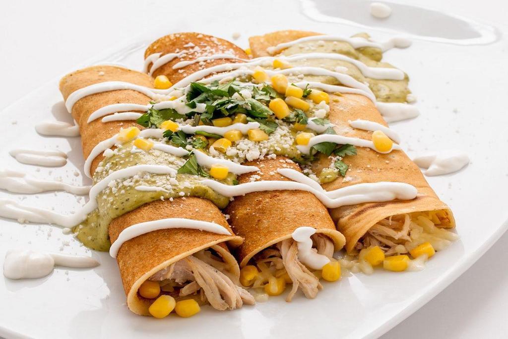 Savory Crepes · Three homemade crepes filled with shredded chicken, corn and jack cheese.  Topped with poblano sauce, corn, cotija cheese and sour cream.