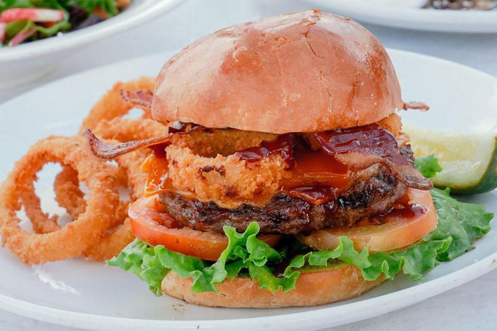 Wild West Burger · Ground beef patty, applewood bacon, onion rings, bbq sauce, cheddar cheese, lettuce, tomato and mayo.