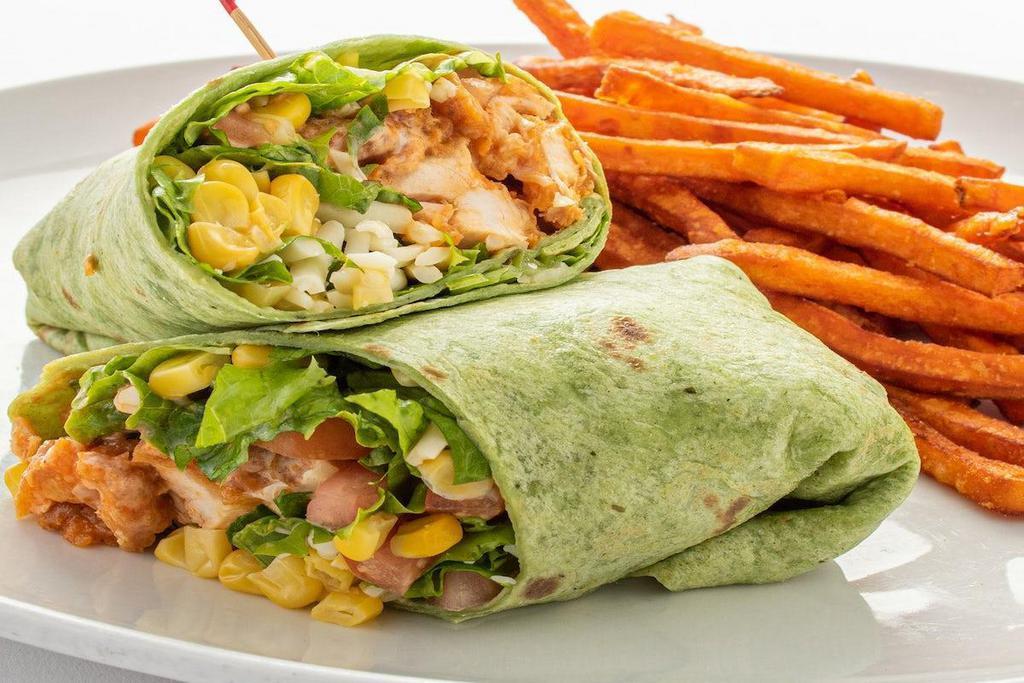 Buffalo Chicken Wrap · Diced crispy chicken strips, lettuce, tomato, jack cheese, corn and ranch dressing wrapped in a spinach tortilla.