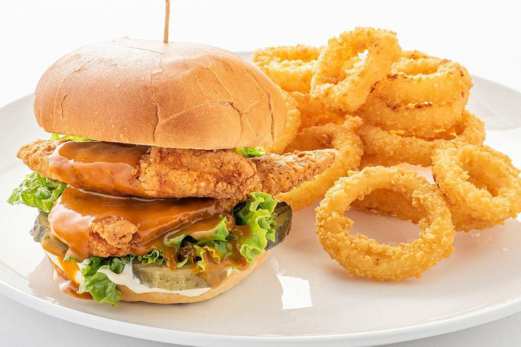 Crispy Chicken Sandwich · Crispy fried chicken strips, shredded lettuce, sliced dill pickles, mayo and Carolina Gold BBQ sauce on a buttered and grilled brioche bun.