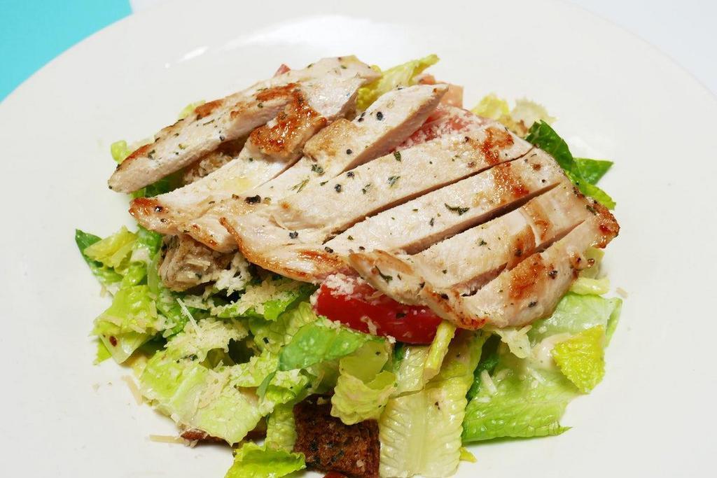 Grilled Chicken Caesar Salad · Grilled chicken breast atop Romaine lettuce tossed in Caesar dressing with tomato, parmesan cheese and croutons.