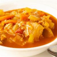Homemade Chicken Veggie Soup · A cup of our homemade chicken veggie soup.