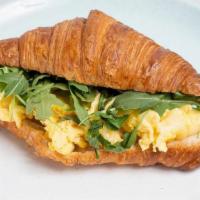 Egg & Cheese W/ Greens Croissant · Freshly baked butter croissant with scrambled eggs, cheddar, arugula with house made Aussie ...