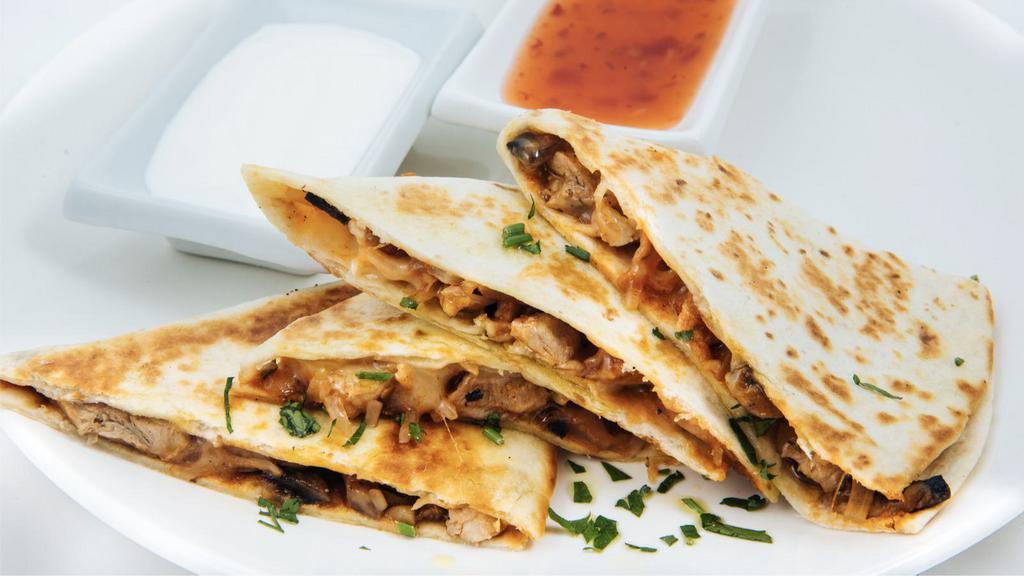 Grilled Chicken Quesadilla · Delicious grilled chicken with pico de gallo, melted mixed cheese and served with salsa and sour cream.
