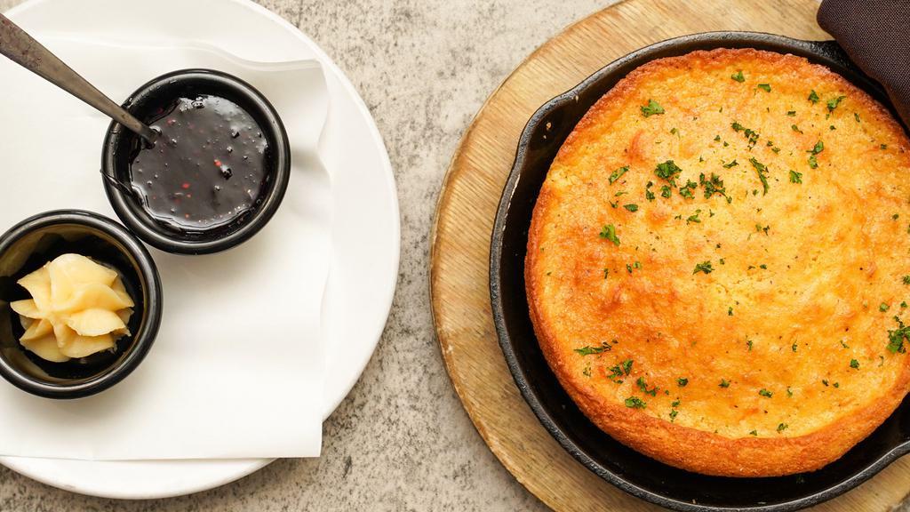 Skillet Cornbread · Sharp cheddar, creamed corn and garlic, honey butter and house made seasonal jam on the side.