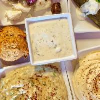 Plate Of Mazza · A little bit of everything included Hummus, Baba Ganoush, Falafel, Grape Leaves, Tzatziki Sa...