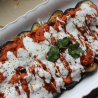 Borani Banjan-Appetizer · Eggplants cooked with tomatoes. Served with yogurt-garlic sauce and topped with lots of drie...