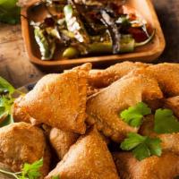 Samosa · Fried or baked dish with a savoury filling, such as chicken, spiced potatoes, onions, peas, ...