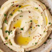 Hummus · As an appetizer and dip, diners scoop hummus with flatbread, such as pita & olive oil.