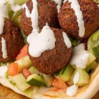 Falafel Gyro Wrap · Falafel wrapped in a pita bread with lettuce, tomato, onion, hummus, jalapeños comes with ga...