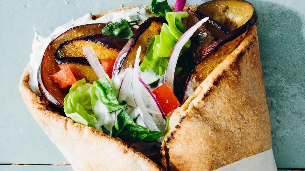 Eggplant Veggie Gyro Wrap · Eggplant wrapped in a pita bread with lettuce, tomato, hummus, jalapeños comes with garlic sauce & house sauce.