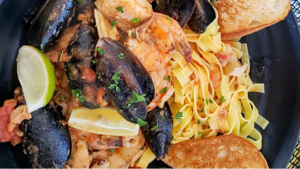 Seafood Cioppino · Traditional Italian stew with mussels, shrimp, clams, fish, calamari and scallops in a garlic tomato sauce with grilled butter toast.