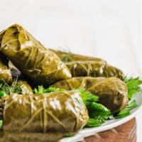 Stuffed Grape Leaves · Rice stuffed grape leaves cooked in lemon juice and extra virgin olive oil.