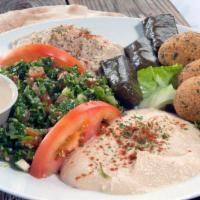 Vegetarian Combo Plate · Hummus, Baba Gannoush, Tabouleh, Veggie Stuffed Grape Leaves, Falafel. Served with pita brea...