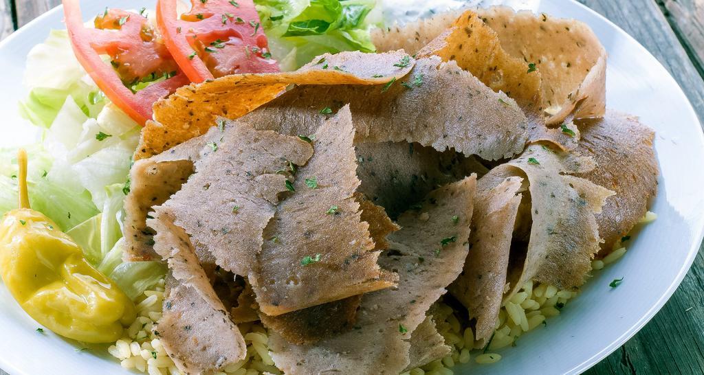 Gyros Plate · Beef/Lamb shaved off a vertical broiler, served with mixed green salad, rice pilaf, tzatziki sauce, pita bread.