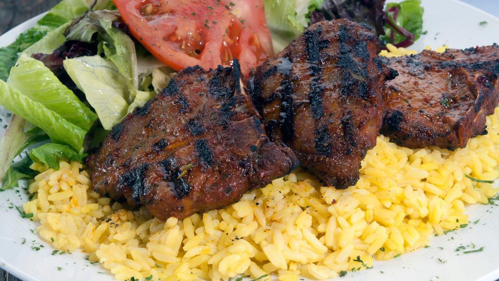 Lamb Chops Plate · Australian Lamb Chops, marinated with fresh garlic, rosemary, olive oil, salt, spices, served with mixed greens salad, rice pilaf, pita bread.