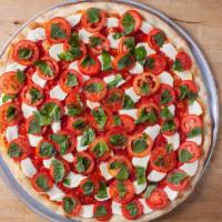 Caprese Pie · A light tomato sauce, mozzarella, tomato slice and basil.