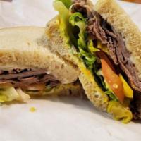 Roast Beef · Tender roast beef, cheddar, horseradish, mayo, mustard, lettuce, tomato, onion on sourdough.