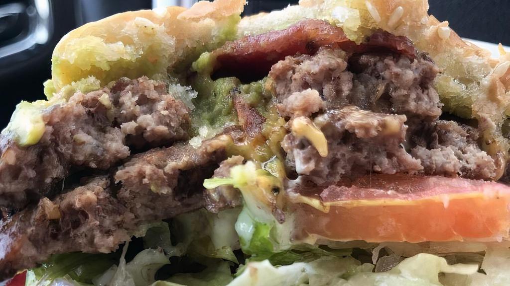 Pops Burger Combo · Served with medium fries and a medium drink, two fresh patties, avocado, bacon, two American cheese, sauce, pickles, onions, lettuce, and tomato