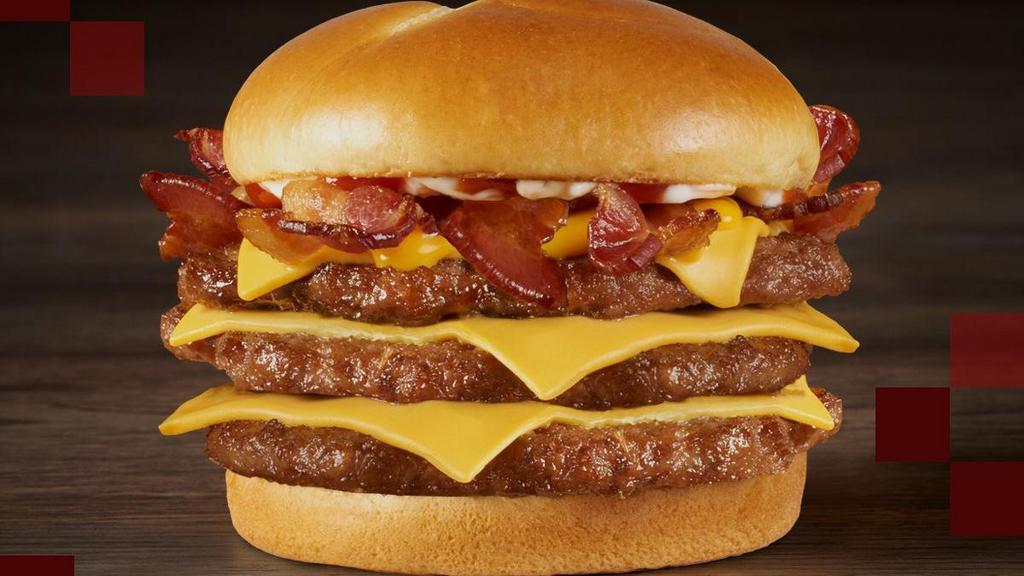Triple Baconzilla!® · Warning: there will be bacon. Take on these three large hand-seasoned, 100% beef hamburger patties piled high with four slices of crispy bacon, two slices of American cheese, melted cheddar cheese, ketchup and mayonnaise all served on a toasted bakery-style bun.