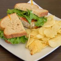 Tuna Sandwich · Made with mayo, lettuce, tomato, on wheat bread and served with ruffles chips.