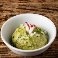 Classic Guacamole · Chunky avocado, tomatoes, onions, fresh lime juice, cilantro, serrano chile.