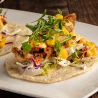Vegan Baja Tacos (2) · Contains gluten. Tempura portobello mushroom, guacamole, cabbage, mango salsa, chipotle vega...