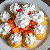 Belgian Waffle And Strawberries · Topped with fresh strawberries and whipped cream.