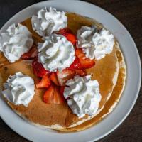 Large Double Stack Pancakes & Strawberries · Topped with fresh strawberries and whipped cream.