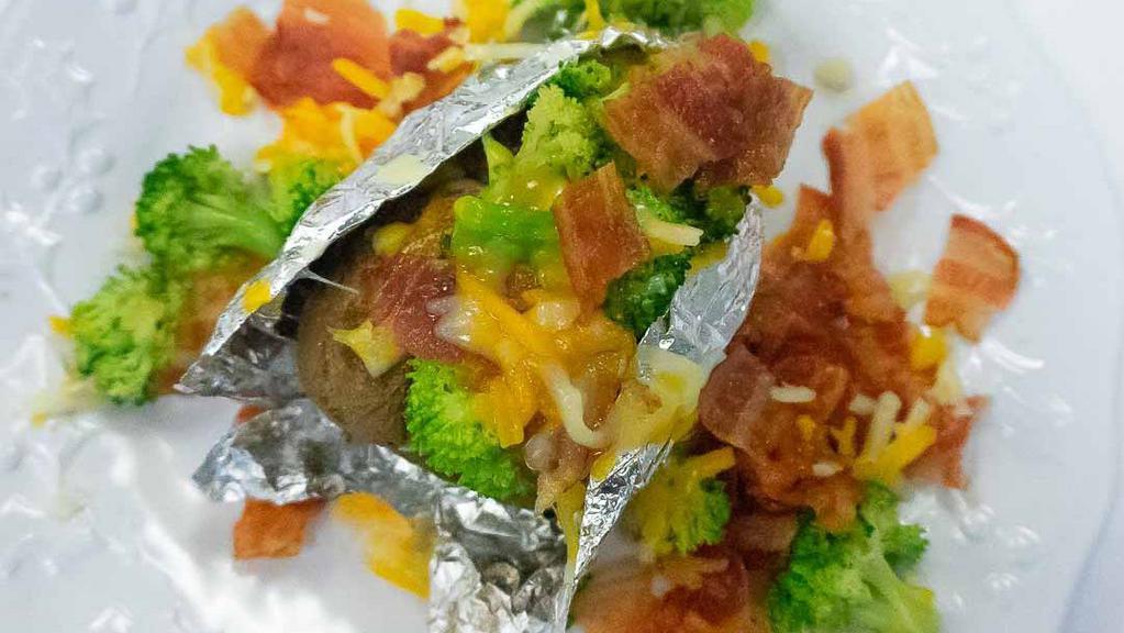 Baked Potato With Butter · add broccoli, cheese or sour cream .50 cents each or 
add bacon, chili or avocado $1.50 each
(Pictured is a loaded baked potato)