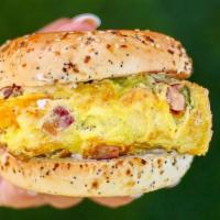 Bagel & Egger · Two eggs, ham and cheese omelette on toasted bagel with cream cheese.