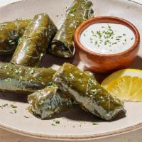 Stuffed Grape Leaves · Grape leaves stuffed with rice, onion and spices. Served with Garlic Feta Sauce. (340 Cals)