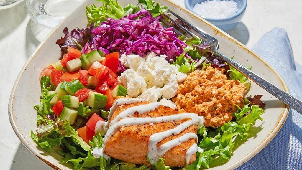Luna Vida Keto Bowl · Grilled sustainable Salmon served on top of a bed of lettuce with lemon vinaigrette, spicy feta, Greek cabbage, cucumber, tomato, and feta drizzled with housemade tzatziki.. *Gluten Free, Keto, High Protein (30-31G), Low Cal (520-590 Cals)