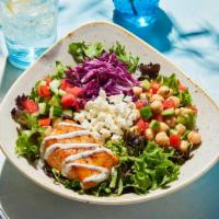 Luna Vida Classic Bowl · Grilled sustainable salmon served on top of a bed of lettuce with lemon vinaigrette, Greek c...