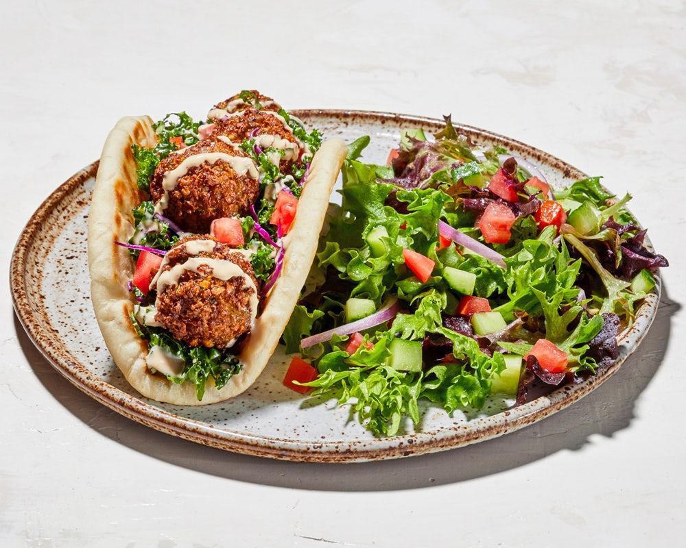 Falafel Pita · Greek cabbage, shredded kale, diced tomato, falafel and sauce wrapped in pita bread (630-840). Served with a side house salad (+85 cals) or fries (+450 cals)