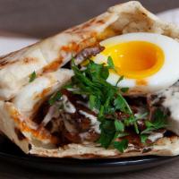 Beef Bourguignon Pita · Beef bourguignon, slow braised beef, and vegetables topped with tahini, soft boiled egg, gre...