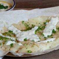 Israeli Purée · Rolled boiled potatoes, lightly grilled topped with Greek yogurt sauce.