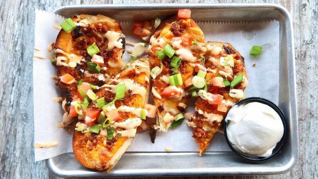 Tater Skins · Chipotle smoked gouda - Cheddar cheese- Applewood bacon- Roma tomatoes- Green onions- Chipotle Ranch